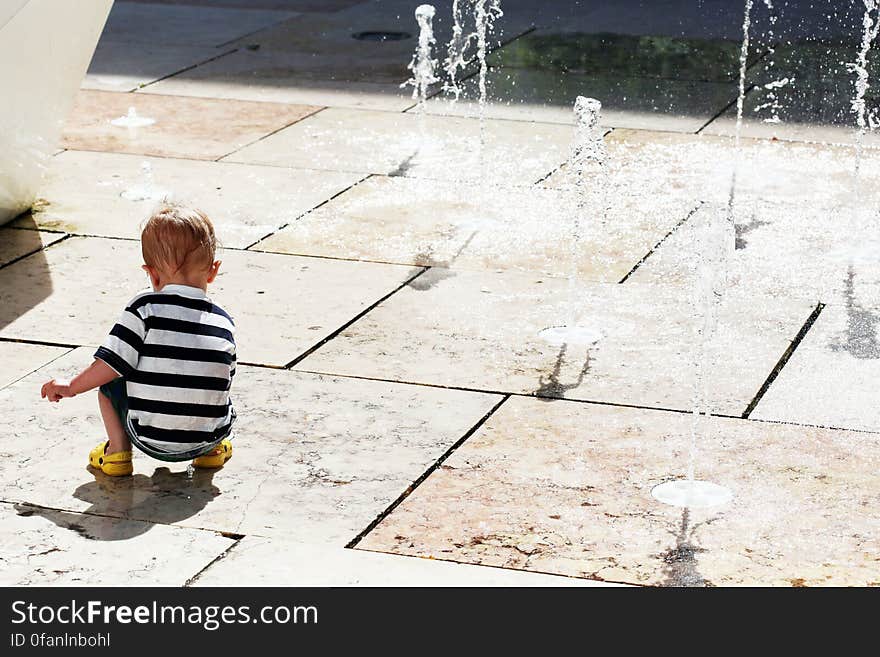 Child Plays With Water Jets