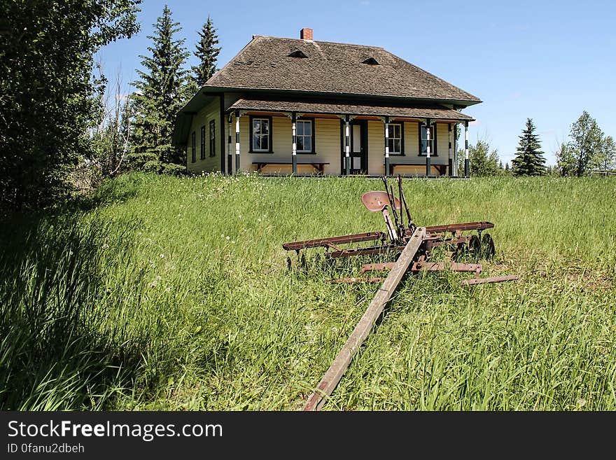 Old homestead and tiller