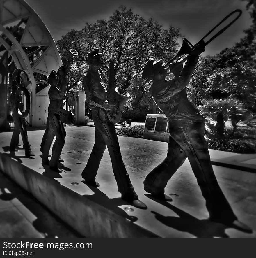 This 2010 work by Sheleen Jones-Adele depicts 6 members of a brass marching band....one playing a trombone..and others a sax, a trumpet, a tuba, drums, etc. The bronze work gives the impression that it is 3 dimensional until seen from an angle that reveals it to be a silhouette relief. This 2010 work by Sheleen Jones-Adele depicts 6 members of a brass marching band....one playing a trombone..and others a sax, a trumpet, a tuba, drums, etc. The bronze work gives the impression that it is 3 dimensional until seen from an angle that reveals it to be a silhouette relief.