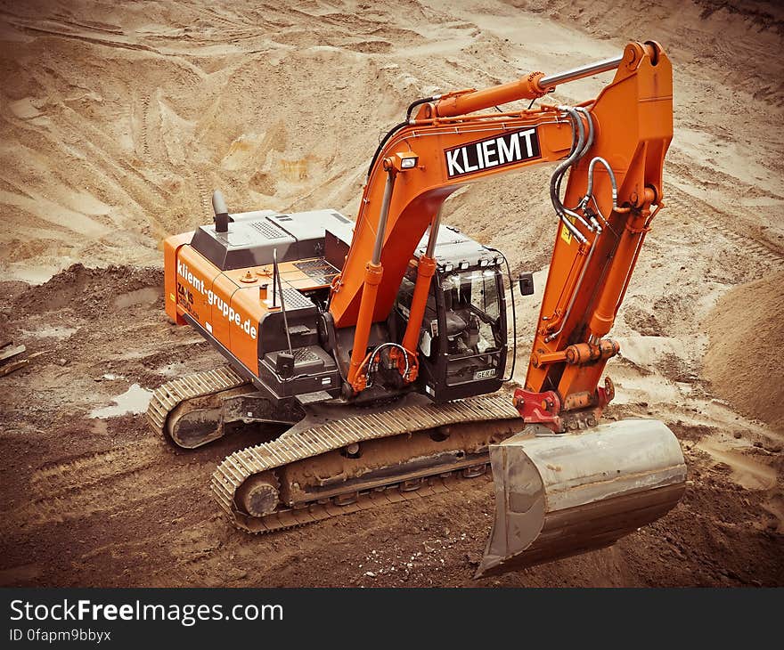 Orange Kliemt Excavator on Brown Soil