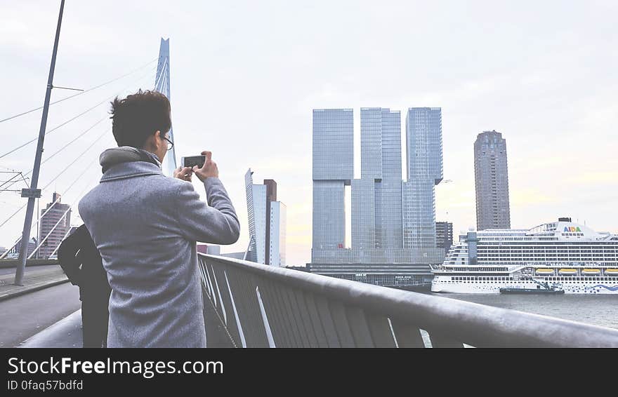 Rear View of Man Photographing Cityscape