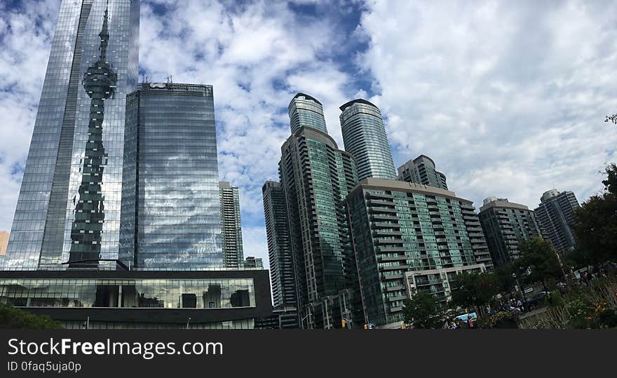 Low Angle View of Skyscrapers Against Cloudy Sky