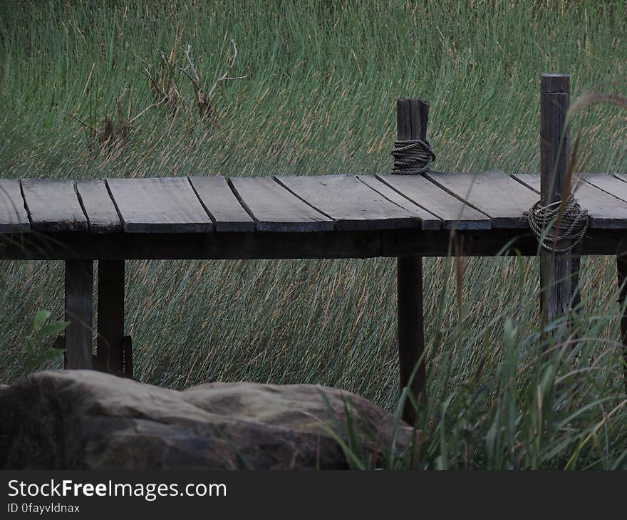 Brown Wooden Dock Near Green Grass Field