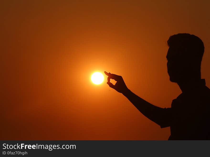 Silhouette of Woman Against Sunset