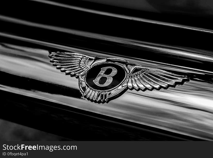 Closeup of Classic Bentley badge on luxury black saloon or sports car. Closeup of Classic Bentley badge on luxury black saloon or sports car.