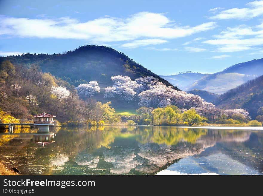 Hills and trees reflecting in calm lake in rural countryside on sunny day in Korea. Hills and trees reflecting in calm lake in rural countryside on sunny day in Korea