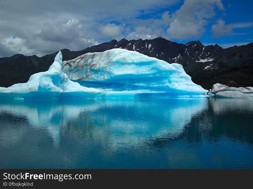 Scenic View of Frozen Lake Against Blue Sky