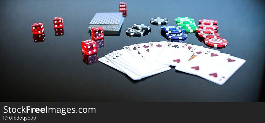 Playing Cards Beside Poker Chips and Dice