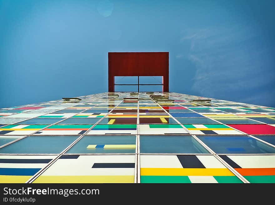 Facade of modern building with colorful panel against blue skies on sunny day. Facade of modern building with colorful panel against blue skies on sunny day.