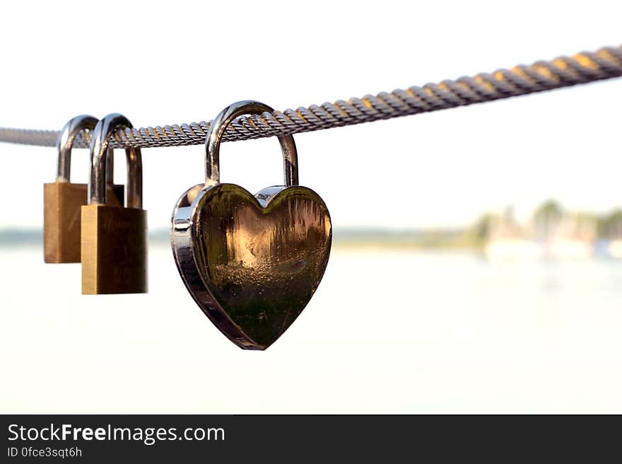 Close-up of Padlocks on Railing Against Sky