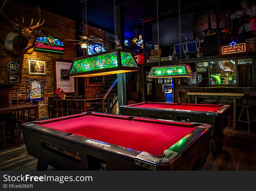 Interior of empty pool hall with vintage lights and neon signs. Interior of empty pool hall with vintage lights and neon signs.