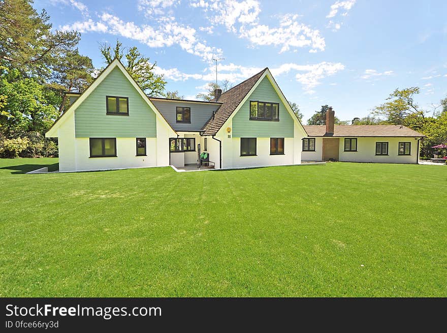 A modern bungalow with a huge lawn in front. A modern bungalow with a huge lawn in front.