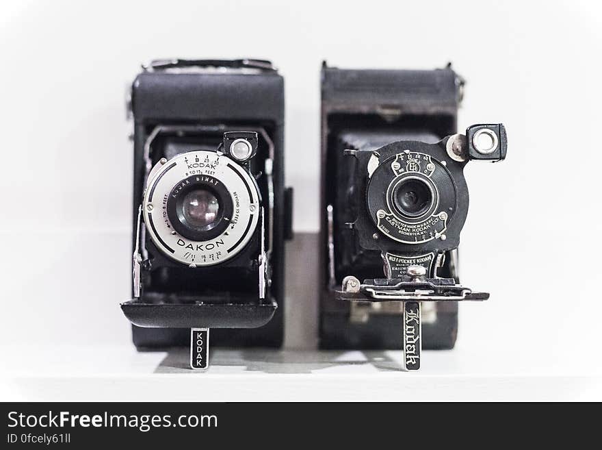 Vintage cameras on shelf in black and white. Vintage cameras on shelf in black and white.