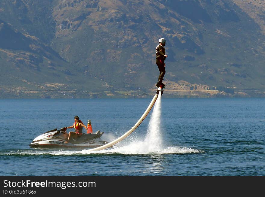 A Flyboard is a type of water jetpack attached to a personal water craft &#x28;PWC&#x29; which supplies propulsion to drive the Flyboard through air and water to perform a sport known as flyboarding. A Flyboard rider stands on a board connected by a long hose to a watercraft. Water is forced under pressure to a pair of boots with jet nozzles underneath which provide thrust for the rider to fly up to 15 metres in the air or to dive headlong through the water. A Flyboard is a type of water jetpack attached to a personal water craft &#x28;PWC&#x29; which supplies propulsion to drive the Flyboard through air and water to perform a sport known as flyboarding. A Flyboard rider stands on a board connected by a long hose to a watercraft. Water is forced under pressure to a pair of boots with jet nozzles underneath which provide thrust for the rider to fly up to 15 metres in the air or to dive headlong through the water.