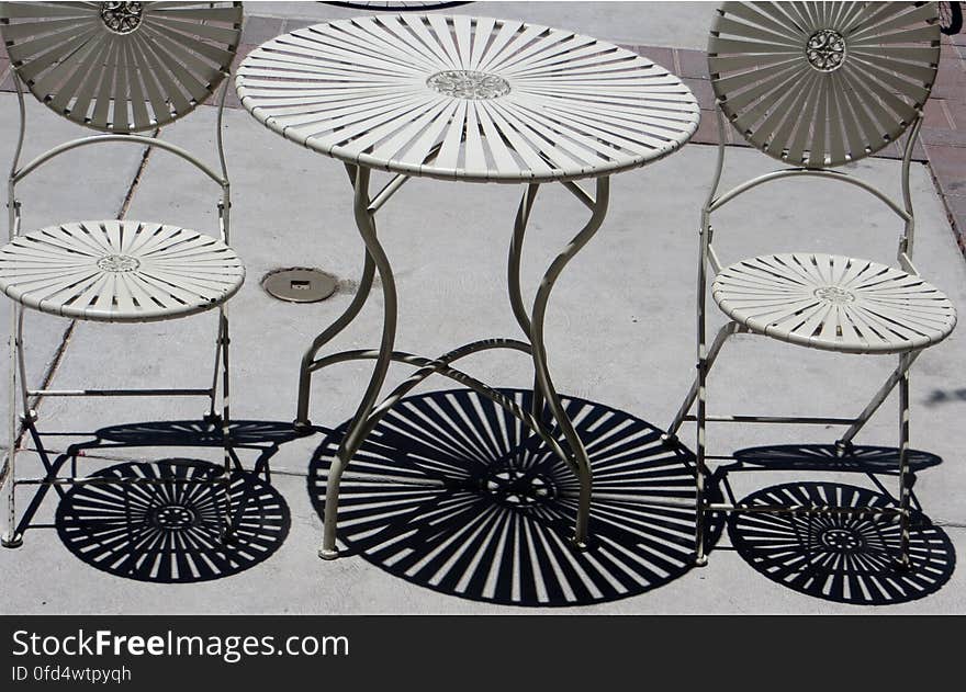 shadows of metal table and chairs