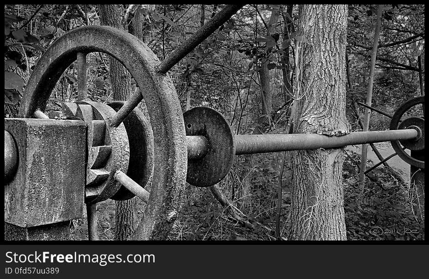 Slowly but surely, the trees are taking back their area. This is the sluice gate wheel from an abandoned mill. Slowly but surely, the trees are taking back their area. This is the sluice gate wheel from an abandoned mill.