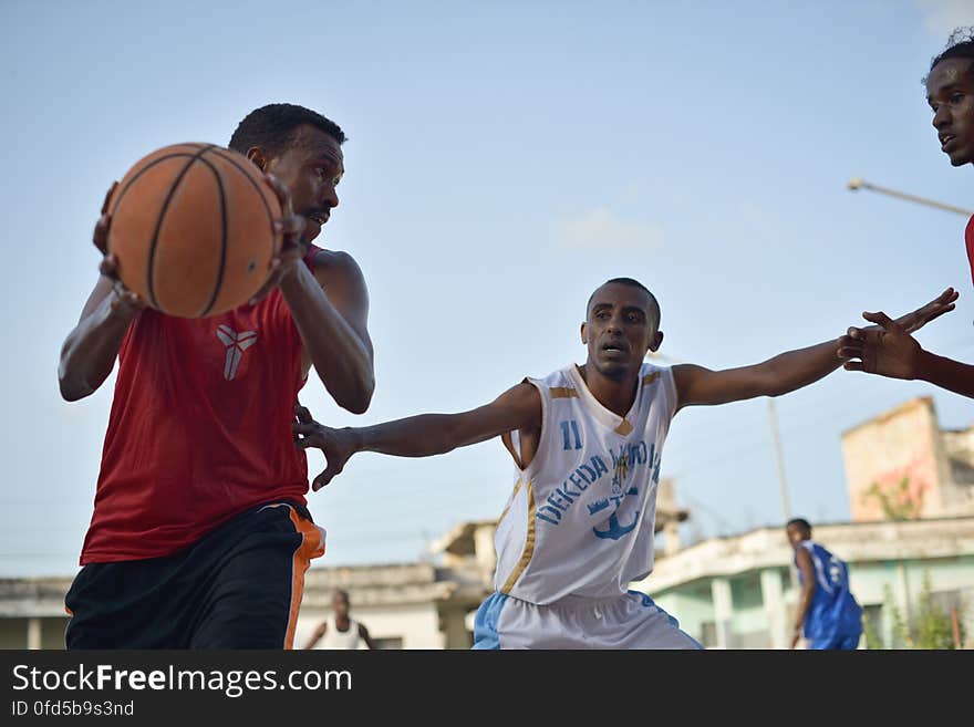 Basketball players play a game on a court in Mogadishu, Somalia, on June 6. Banned under the extremist group, Al Shabaab, Basketball is once again making a resurgence in Mogadishu. Today at least a dozen teams in the city play in a league and both men and women are coming out to play the sport. AU UN IST PHOTO / TOBIN JONES. Basketball players play a game on a court in Mogadishu, Somalia, on June 6. Banned under the extremist group, Al Shabaab, Basketball is once again making a resurgence in Mogadishu. Today at least a dozen teams in the city play in a league and both men and women are coming out to play the sport. AU UN IST PHOTO / TOBIN JONES