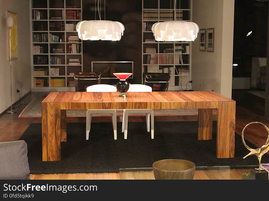 A contemporary apartment and a wood dining table.