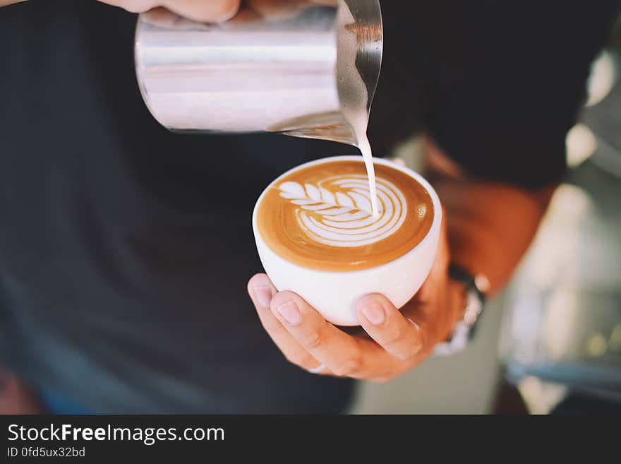 Close-up of Hand Holding Cappuccino