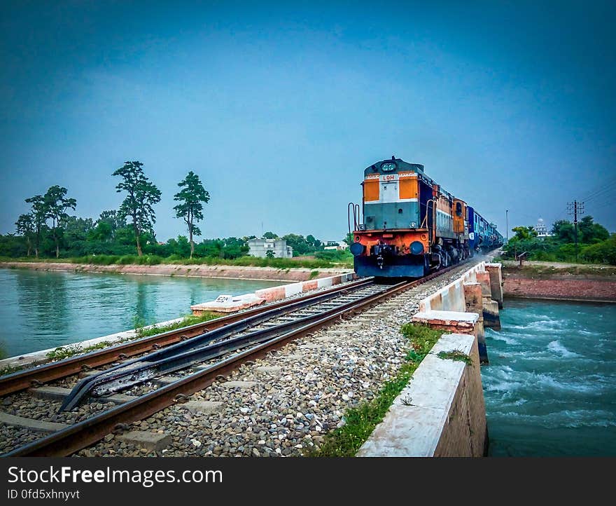 Train by Trees Against Blue Sky