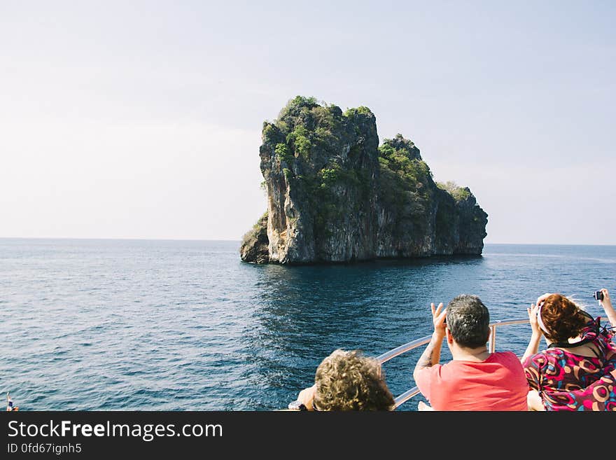 People on Rock by Sea