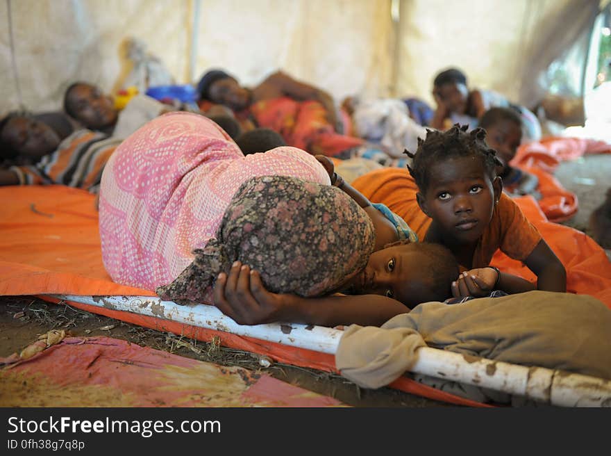 Women and children sleep in a makeshift hospital erected at an AMISOM military camp to help those affected by recent flooding and clan conflict near Jowhar, Somalia, on November 12. Heavy rains in Somalia, coupled with recent disputes between clans, has resulted in over four thousand IDPs seeking shelter at an AMISOM military base near the town of Jowhar, with more arriving daily. AU UN IST Photo / Tobin Jones. Women and children sleep in a makeshift hospital erected at an AMISOM military camp to help those affected by recent flooding and clan conflict near Jowhar, Somalia, on November 12. Heavy rains in Somalia, coupled with recent disputes between clans, has resulted in over four thousand IDPs seeking shelter at an AMISOM military base near the town of Jowhar, with more arriving daily. AU UN IST Photo / Tobin Jones