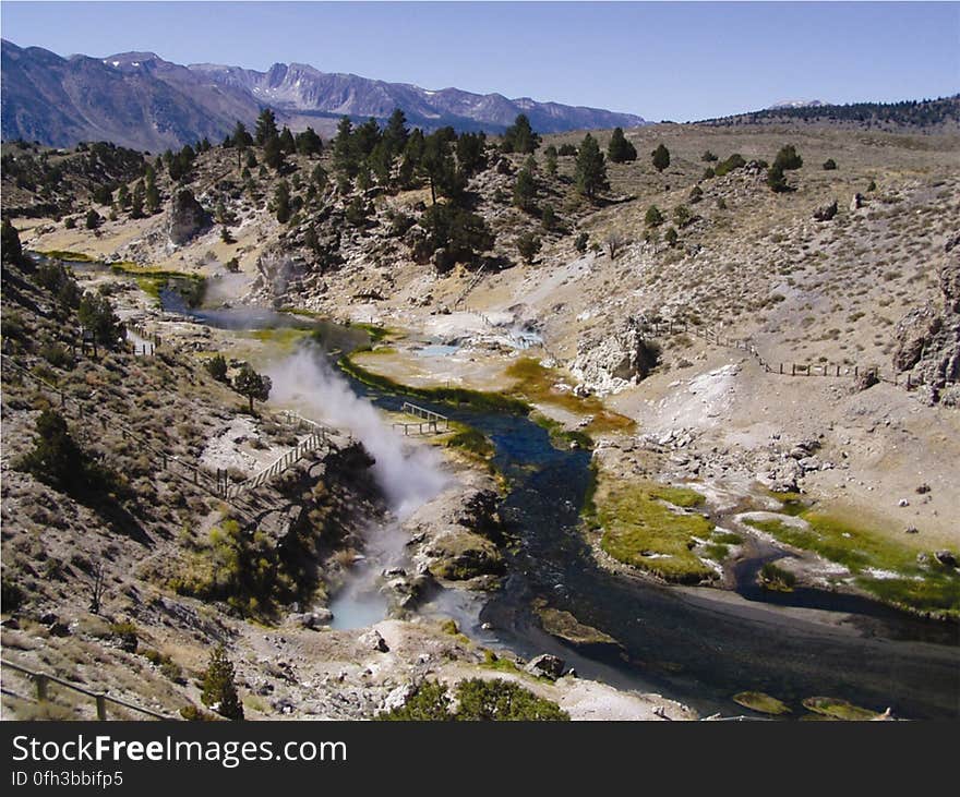 Hot Creek flows through the Long Valley Caldera in a volcanically active region of east-central California. This stretch of the creek, looking upstream to the southwest, has long been a popular recreation area because of the warm waters from its thermal springs. These springs, however, are unpredictable and can suddenly erupt with violence and at boiling temperature. Because of this danger, the U.S. Forest Service has had to close parts of the Hot Creek Geologic Site to visitors. The same geothermal reservoir that feeds Hot Creek provides heat for geothermal electric power production at nearby Casa Diablo. Read more about Hot Creek and it&#x27;s geothermal properties at pubs.usgs.gov/fs/2007/3045/fs2007-3045.pdf Photo credit: Chris Farrar, USGS​. Hot Creek flows through the Long Valley Caldera in a volcanically active region of east-central California. This stretch of the creek, looking upstream to the southwest, has long been a popular recreation area because of the warm waters from its thermal springs. These springs, however, are unpredictable and can suddenly erupt with violence and at boiling temperature. Because of this danger, the U.S. Forest Service has had to close parts of the Hot Creek Geologic Site to visitors. The same geothermal reservoir that feeds Hot Creek provides heat for geothermal electric power production at nearby Casa Diablo. Read more about Hot Creek and it&#x27;s geothermal properties at pubs.usgs.gov/fs/2007/3045/fs2007-3045.pdf Photo credit: Chris Farrar, USGS​.