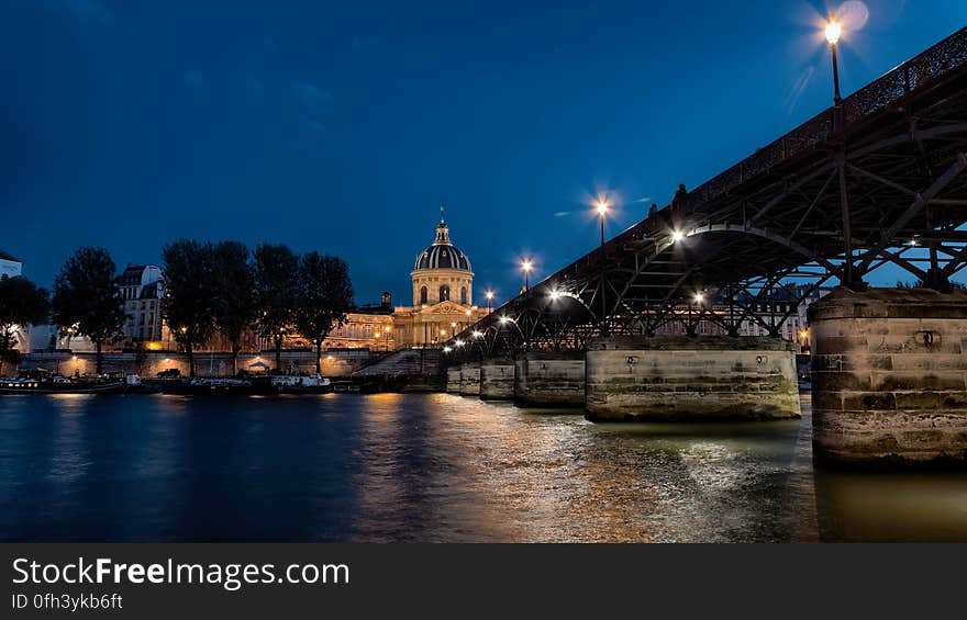 A night-time view of the Pont des Arts leading to the Institut de France. A night-time view of the Pont des Arts leading to the Institut de France.
