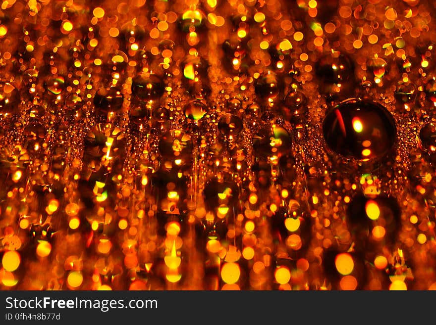 A background of blurred hanging orange glass beads. A background of blurred hanging orange glass beads.