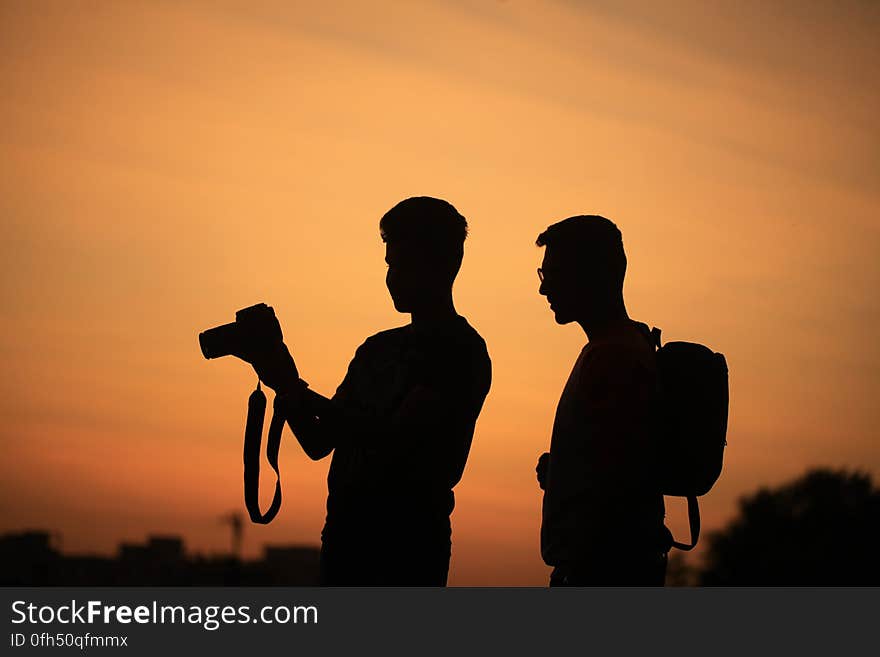 A pair of men photographing at sunset. A pair of men photographing at sunset.