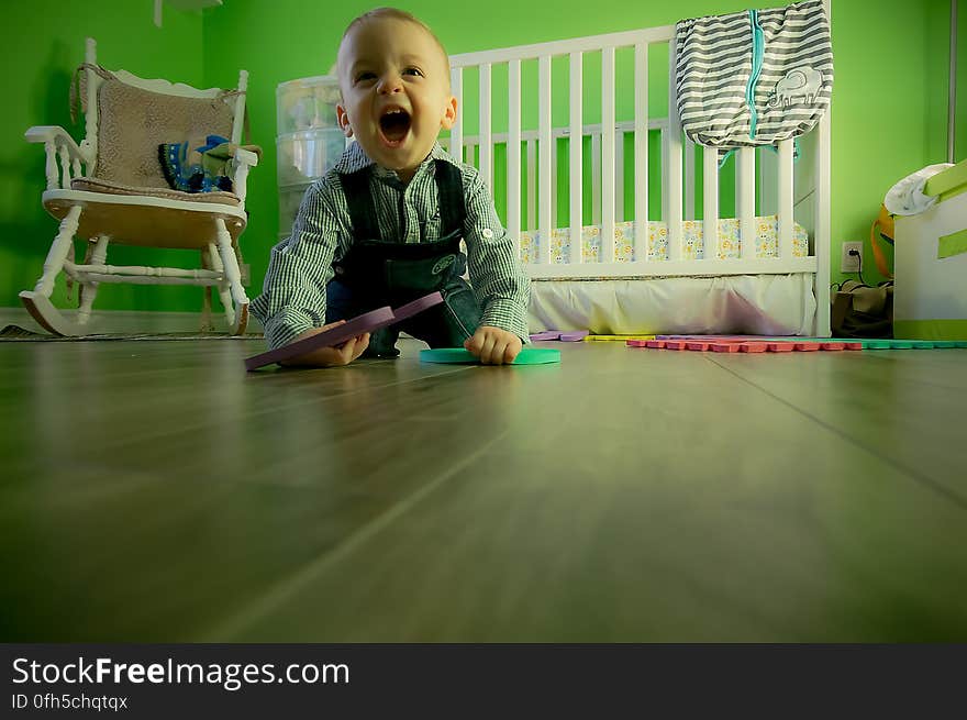 Full Length of Boy Sitting on Floor