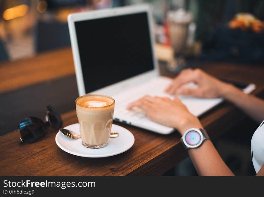 Midsection of Man Using Mobile Phone While Sitting on Table