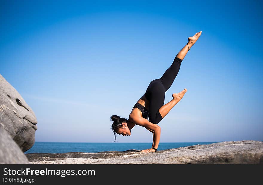 Low Angle View of Woman Relaxing on Beach Against Blue Sky