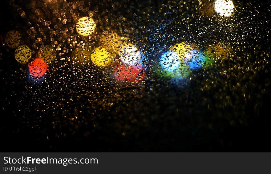 Raindrops on Road Seen Through Car Window