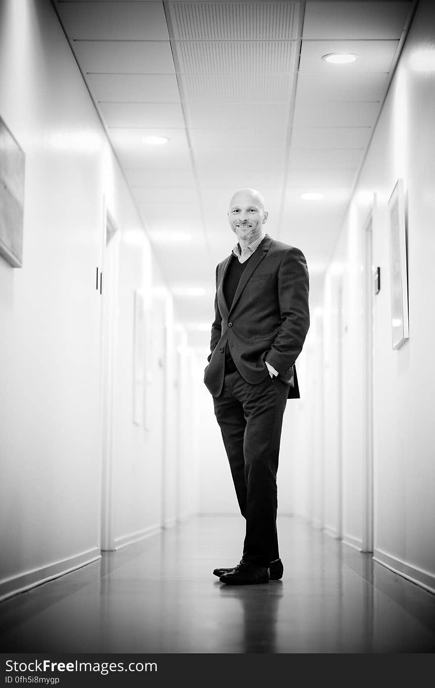 Full Length Portrait of Man Standing in Corridor