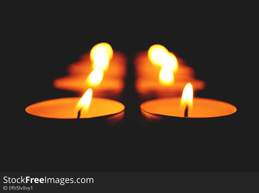 Close-up of Illuminated Candle Against Black Background