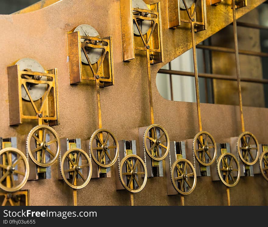 These components perform key computations for Tide Predicting Machine No. 2, a special purpose mechanical analog computer for predicting the height and time of high and low tides. The tide prediction formula implemented by the machine includes the addition of a series of cosine terms. The triangular metal pieces are part of slotted yoke cranks which convert circular motion to a vertical motion that traces a sinusoid. Each slotted yoke crank is connected by a shaft to a pulley, which causes the pulley to follow the sinusoidal motion. A chain going over and under pulleys sums each of their deflections to compute the tide. The U.S. government used Tide Predicting Machine No. 2 from 1910 to 1965 to predict tides for ports around the world. The machine, also known as “Old Brass Brains,” uses an intricate arrangement of gears, pulleys, chains, slides, and other mechanical components to perform the computations. A person using the machine would require 2-3 days to compute a year’s tides at one location. A person performing the same calculations by hand would require hundreds of days to perform the work. The machine is 10.8 feet &#x28;3.3 m&#x29; long, 6.2 feet &#x28;1.9 m&#x29; high, and 2.0 feet &#x28;0.61 m&#x29; wide and weighs approximately 2,500 pounds &#x28;1134 kg&#x29;. The operator powers the machine with a hand crank. These components perform key computations for Tide Predicting Machine No. 2, a special purpose mechanical analog computer for predicting the height and time of high and low tides. The tide prediction formula implemented by the machine includes the addition of a series of cosine terms. The triangular metal pieces are part of slotted yoke cranks which convert circular motion to a vertical motion that traces a sinusoid. Each slotted yoke crank is connected by a shaft to a pulley, which causes the pulley to follow the sinusoidal motion. A chain going over and under pulleys sums each of their deflections to compute the tide. The U.S. government used Tide Predicting Machine No. 2 from 1910 to 1965 to predict tides for ports around the world. The machine, also known as “Old Brass Brains,” uses an intricate arrangement of gears, pulleys, chains, slides, and other mechanical components to perform the computations. A person using the machine would require 2-3 days to compute a year’s tides at one location. A person performing the same calculations by hand would require hundreds of days to perform the work. The machine is 10.8 feet &#x28;3.3 m&#x29; long, 6.2 feet &#x28;1.9 m&#x29; high, and 2.0 feet &#x28;0.61 m&#x29; wide and weighs approximately 2,500 pounds &#x28;1134 kg&#x29;. The operator powers the machine with a hand crank.