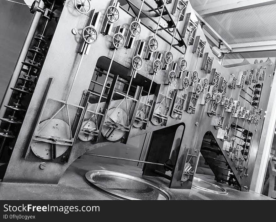 This photo shows the largest of the three sections of Tide Predicting Machine No. 2, a special purpose mechanical analog computer for predicting the height and time of high and low tides. The gears on the left transmit power from the hand crank. The components on the right contribute to the computation of the time of high and low tides. The U.S. government used Tide Predicting Machine No. 2 from 1910 to 1965 to produce its tide predictions. The machine, also known as “Old Brass Brains,” uses an intricate arrangement of gears, pulleys, chains, slides, and other mechanical components to perform the computations. A person using the machine would require 2-3 days to compute a year’s tides at one location. A person performing the same calculations by hand would require hundreds of days to perform the work. The machine is 10.8 feet &#x28;3.3 m&#x29; long, 6.2 feet &#x28;1.9 m&#x29; high, and 2.0 feet &#x28;0.61 m&#x29; wide and weighs approximately 2,500 pounds &#x28;1134 kg&#x29;. The operator powers the machine with a hand crank. The National Oceanic and Atmospheric Administration &#x28;NOAA&#x29; occasionally displays the machine at its facility in Silver Spring, Maryland. This photo shows the largest of the three sections of Tide Predicting Machine No. 2, a special purpose mechanical analog computer for predicting the height and time of high and low tides. The gears on the left transmit power from the hand crank. The components on the right contribute to the computation of the time of high and low tides. The U.S. government used Tide Predicting Machine No. 2 from 1910 to 1965 to produce its tide predictions. The machine, also known as “Old Brass Brains,” uses an intricate arrangement of gears, pulleys, chains, slides, and other mechanical components to perform the computations. A person using the machine would require 2-3 days to compute a year’s tides at one location. A person performing the same calculations by hand would require hundreds of days to perform the work. The machine is 10.8 feet &#x28;3.3 m&#x29; long, 6.2 feet &#x28;1.9 m&#x29; high, and 2.0 feet &#x28;0.61 m&#x29; wide and weighs approximately 2,500 pounds &#x28;1134 kg&#x29;. The operator powers the machine with a hand crank. The National Oceanic and Atmospheric Administration &#x28;NOAA&#x29; occasionally displays the machine at its facility in Silver Spring, Maryland.