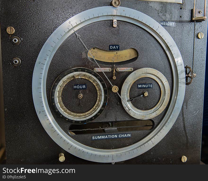 Dials for tide height &#x28;outer ring&#x29;, date, and time on Tide Predicting Machine No. 2, a special purpose mechanical analog computer for predicting the height and time of high and low tides. When the machine was in operation, the operator recorded the height and time of high and low tides, which were later reproduced in printed tide tables. The U.S. government used Tide Predicting Machine No. 2 from 1910 to 1965 to predict tides for ports around the world. The machine, also known as â€œOld Brass Brains,â€ uses an intricate arrangement of gears, pulleys, chains, slides, and other mechanical components to perform the computations. A person using the machine would require 2-3 days to compute a yearâ€™s tides at one location. A person performing the same calculations by hand would require hundreds of days to perform the work. The machine is 10.8 feet &#x28;3.3 m&#x29; long, 6.2 feet &#x28;1.9 m&#x29; high, and 2.0 feet &#x28;0.61 m&#x29; wide and weighs approximately 2,500 pounds &#x28;1134 kg&#x29;. The operator powers the machine with a hand crank. Dials for tide height &#x28;outer ring&#x29;, date, and time on Tide Predicting Machine No. 2, a special purpose mechanical analog computer for predicting the height and time of high and low tides. When the machine was in operation, the operator recorded the height and time of high and low tides, which were later reproduced in printed tide tables. The U.S. government used Tide Predicting Machine No. 2 from 1910 to 1965 to predict tides for ports around the world. The machine, also known as â€œOld Brass Brains,â€ uses an intricate arrangement of gears, pulleys, chains, slides, and other mechanical components to perform the computations. A person using the machine would require 2-3 days to compute a yearâ€™s tides at one location. A person performing the same calculations by hand would require hundreds of days to perform the work. The machine is 10.8 feet &#x28;3.3 m&#x29; long, 6.2 feet &#x28;1.9 m&#x29; high, and 2.0 feet &#x28;0.61 m&#x29; wide and weighs approximately 2,500 pounds &#x28;1134 kg&#x29;. The operator powers the machine with a hand crank.