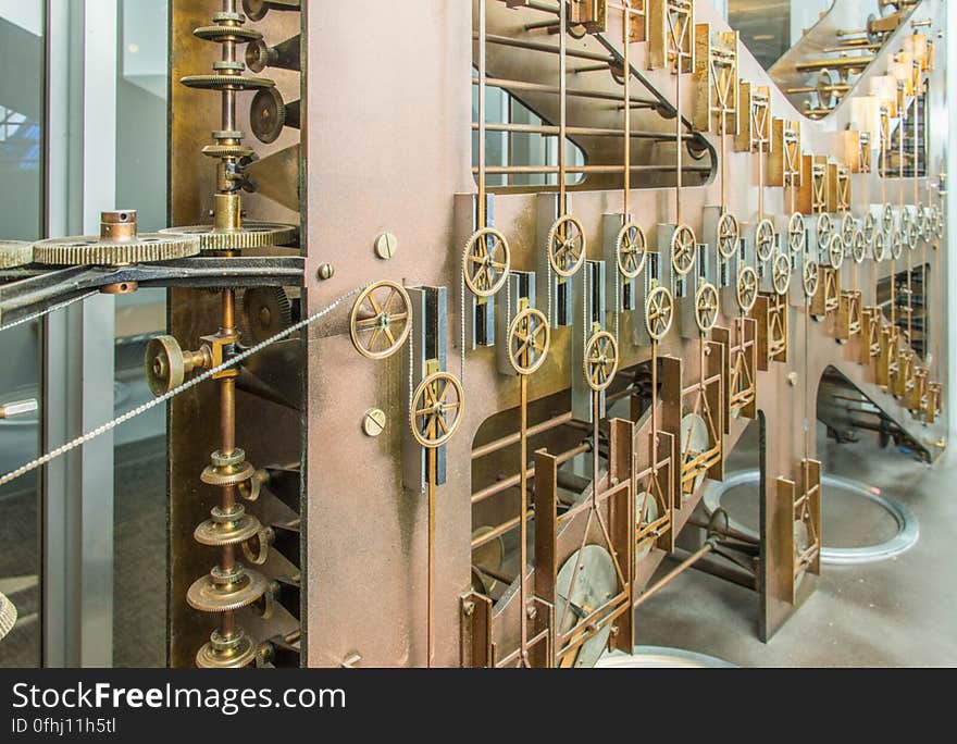 This photo shows the largest of the three sections of Tide Predicting Machine No. 2, a special purpose mechanical analog computer for predicting the height and time of high and low tides. The gears on the left transmit power from the hand crank. The components on the right contribute to the computation of the time of high and low tides. The U.S. government used Tide Predicting Machine No. 2 from 1910 to 1965 to predict tides for ports around the world. The machine, also known as â€œOld Brass Brains,â€ uses an intricate arrangement of gears, pulleys, chains, slides, and other mechanical components to perform the computations. A person using the machine would require 2-3 days to compute a yearâ€™s tides at one location. A person performing the same calculations by hand would require hundreds of days to perform the work. The machine is 10.8 feet &#x28;3.3 m&#x29; long, 6.2 feet &#x28;1.9 m&#x29; high, and 2.0 feet &#x28;0.61 m&#x29; wide and weighs approximately 2,500 pounds &#x28;1134 kg&#x29;. The operator powers the machine with a hand crank. The National Oceanographic and Atmospheric Administration &#x28;NOAA&#x29; maintains the machine in working order. This photo shows the largest of the three sections of Tide Predicting Machine No. 2, a special purpose mechanical analog computer for predicting the height and time of high and low tides. The gears on the left transmit power from the hand crank. The components on the right contribute to the computation of the time of high and low tides. The U.S. government used Tide Predicting Machine No. 2 from 1910 to 1965 to predict tides for ports around the world. The machine, also known as â€œOld Brass Brains,â€ uses an intricate arrangement of gears, pulleys, chains, slides, and other mechanical components to perform the computations. A person using the machine would require 2-3 days to compute a yearâ€™s tides at one location. A person performing the same calculations by hand would require hundreds of days to perform the work. The machine is 10.8 feet &#x28;3.3 m&#x29; long, 6.2 feet &#x28;1.9 m&#x29; high, and 2.0 feet &#x28;0.61 m&#x29; wide and weighs approximately 2,500 pounds &#x28;1134 kg&#x29;. The operator powers the machine with a hand crank. The National Oceanographic and Atmospheric Administration &#x28;NOAA&#x29; maintains the machine in working order.