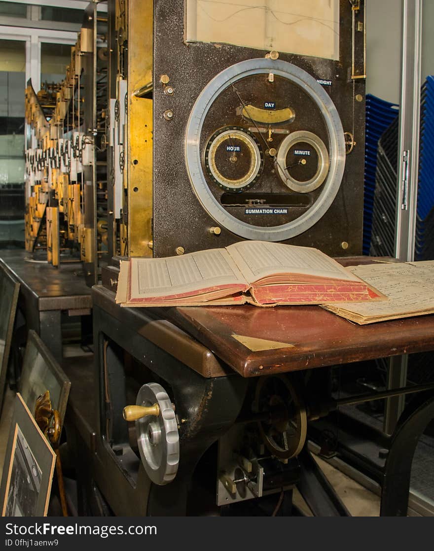 Tide Predicting Machine No. 2 is a special purpose mechanical analog computer for predicting the height and time of high and low tides. When the machine was routinely used, the operator would sit at the desk and turn the crank on the left, which powered the machine. Mechanical components, partially visible on the left, computed the height of tides. These were displayed on the paper tide curve visible at the top right and on the dial below the paper. The U.S. government used Tide Predicting Machine No. 2 from 1910 to 1965 to predict tides for ports around the world. The machine, also known as â€œOld Brass Brains,â€ uses an intricate arrangement of gears, pulleys, chains, slides, and other mechanical components to perform the computations. A person using the machine would require 2-3 days to compute a yearâ€™s tides at one location. A person performing the same calculations by hand would require hundreds of days to perform the work. The machine is 10.8 feet &#x28;3.3 m&#x29; long, 6.2 feet &#x28;1.9 m&#x29; high, and 2.0 feet &#x28;0.61 m&#x29; wide and weighs approximately 2,500 pounds &#x28;1134 kg&#x29;. The operator powers the machine with a hand crank. The National Oceanic and Atmospheric Administration &#x28;NOAA&#x29; occasionally displays the machine at its facility in Silver Spring, Maryland. Tide Predicting Machine No. 2 is a special purpose mechanical analog computer for predicting the height and time of high and low tides. When the machine was routinely used, the operator would sit at the desk and turn the crank on the left, which powered the machine. Mechanical components, partially visible on the left, computed the height of tides. These were displayed on the paper tide curve visible at the top right and on the dial below the paper. The U.S. government used Tide Predicting Machine No. 2 from 1910 to 1965 to predict tides for ports around the world. The machine, also known as â€œOld Brass Brains,â€ uses an intricate arrangement of gears, pulleys, chains, slides, and other mechanical components to perform the computations. A person using the machine would require 2-3 days to compute a yearâ€™s tides at one location. A person performing the same calculations by hand would require hundreds of days to perform the work. The machine is 10.8 feet &#x28;3.3 m&#x29; long, 6.2 feet &#x28;1.9 m&#x29; high, and 2.0 feet &#x28;0.61 m&#x29; wide and weighs approximately 2,500 pounds &#x28;1134 kg&#x29;. The operator powers the machine with a hand crank. The National Oceanic and Atmospheric Administration &#x28;NOAA&#x29; occasionally displays the machine at its facility in Silver Spring, Maryland.