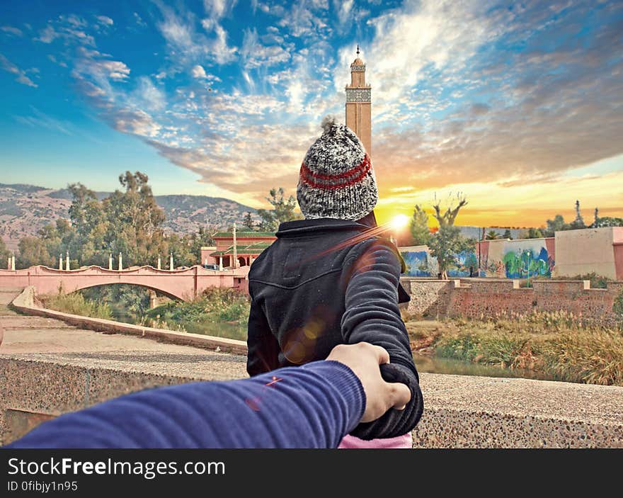 Rear View of Man Photographing Cityscape Against Sky