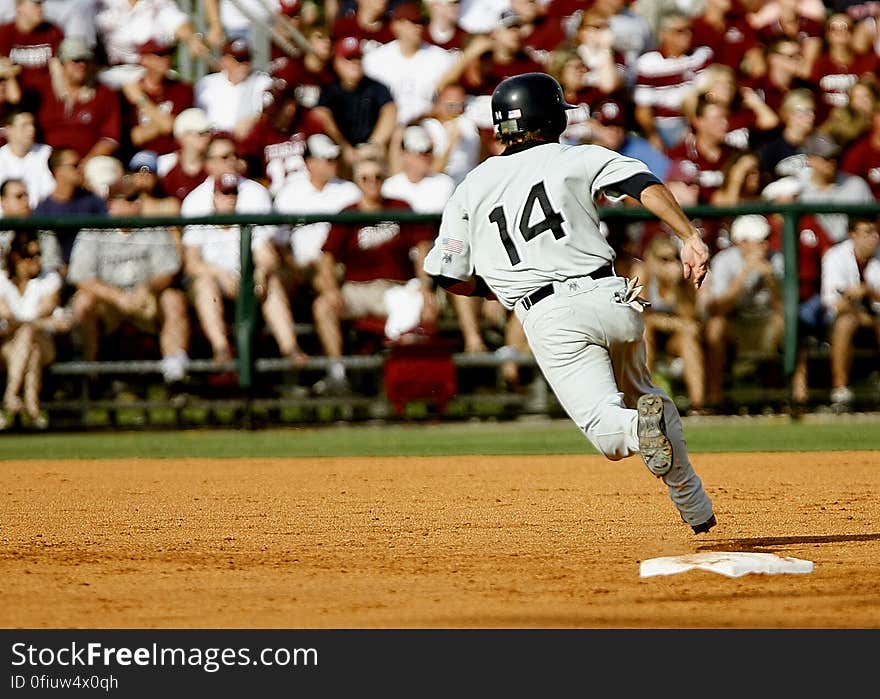 Baseball Player Number 14 Chasing Goal on Baseball Field