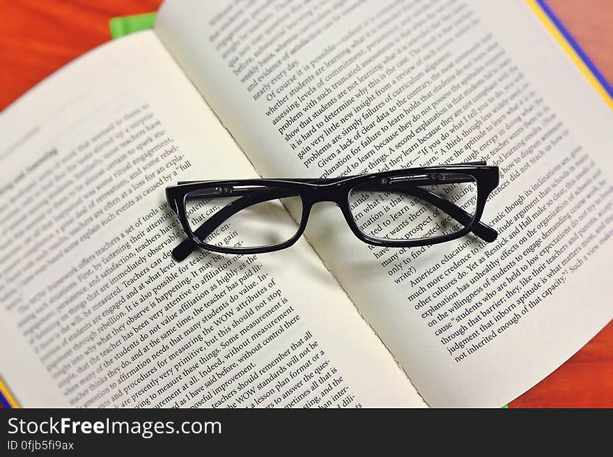 Black Framed Eyeglasses on Book