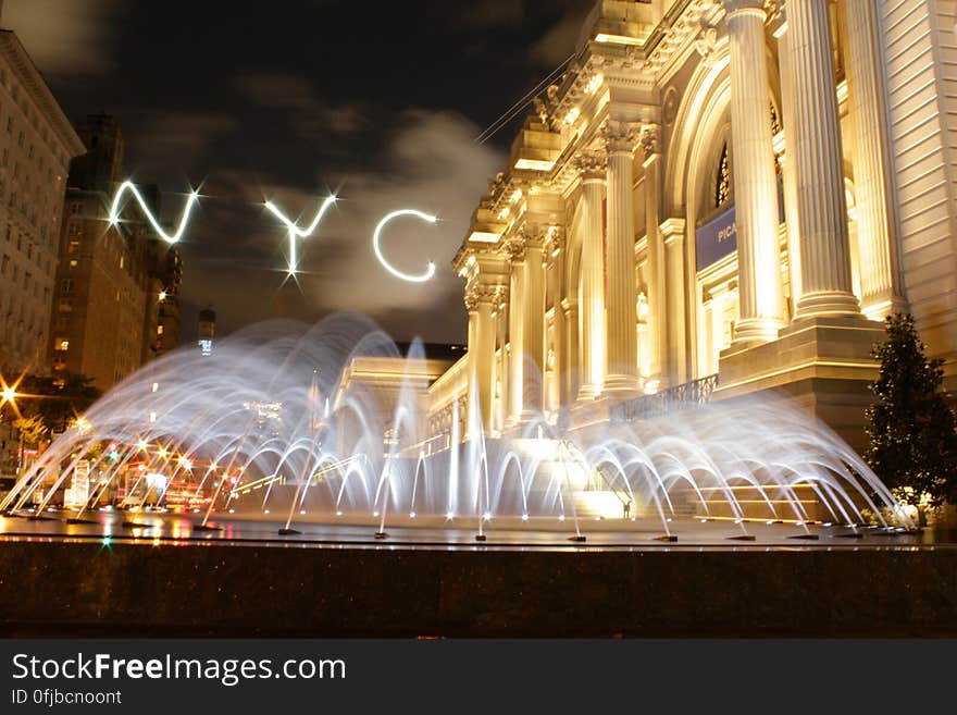 A view from New York City at night with a fountain. A view from New York City at night with a fountain.