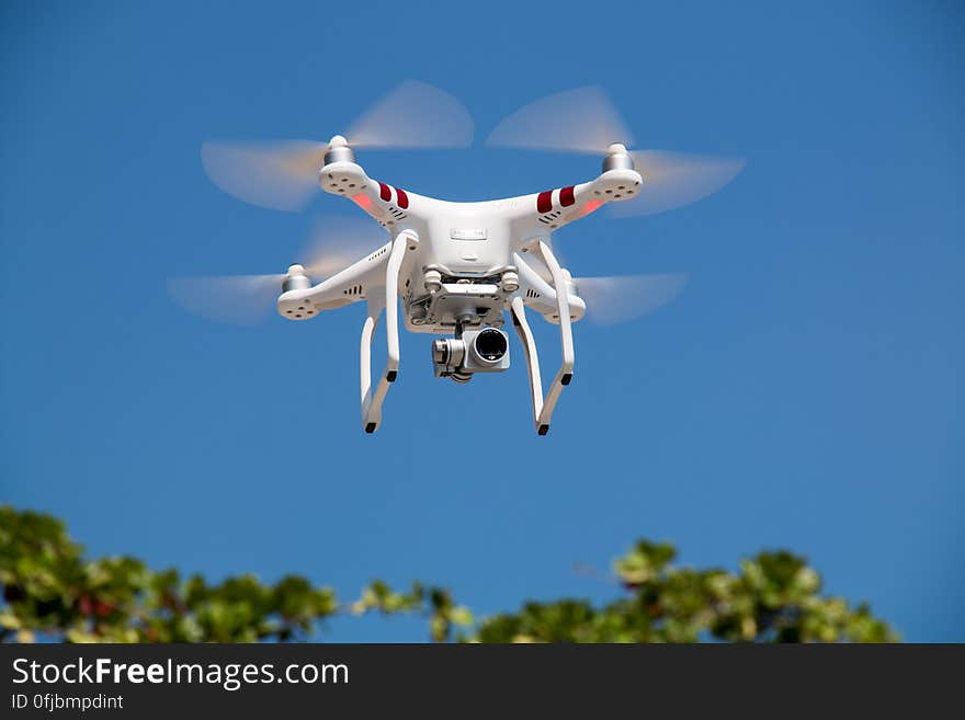 Drone Flying Against Blue Sky