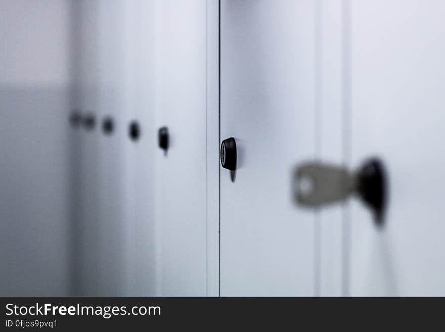 Row of white painted closed lockers. Row of white painted closed lockers.