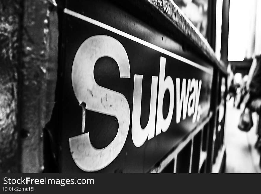 A black and white image of a subway sign.