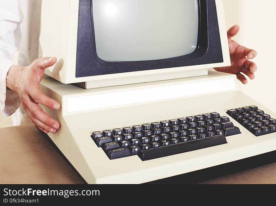 A person holding a classic Commodore PET personal computer.