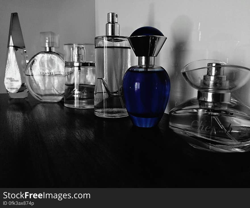 Collection of glass perfume bottles on shelf. Collection of glass perfume bottles on shelf.